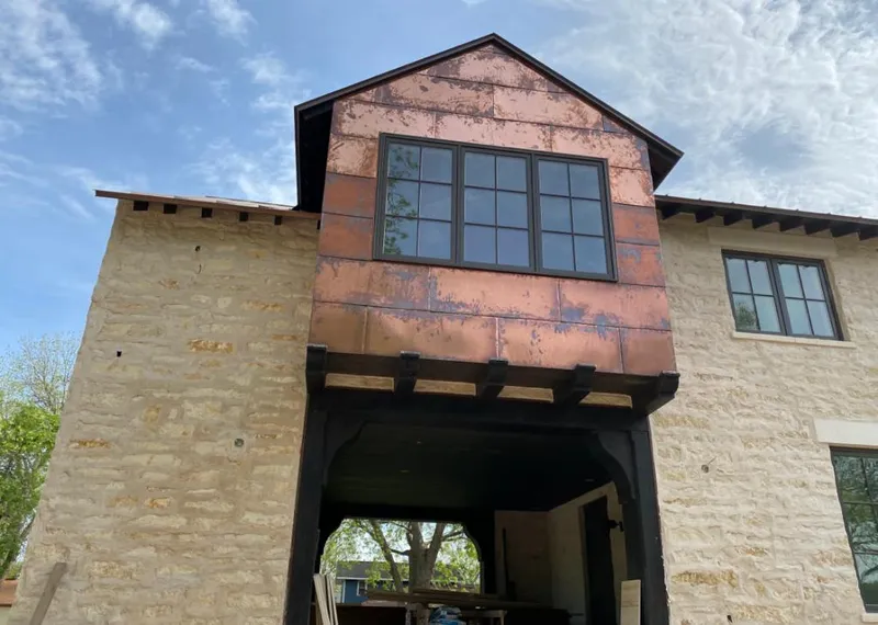 Copper metal panel facade on a stone building for Metal Roof Coating in Longview